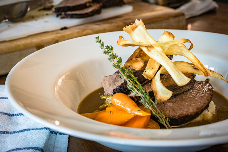 Pot roasted beef brisket with root vegetable mash, parsnip crisps and horseradish