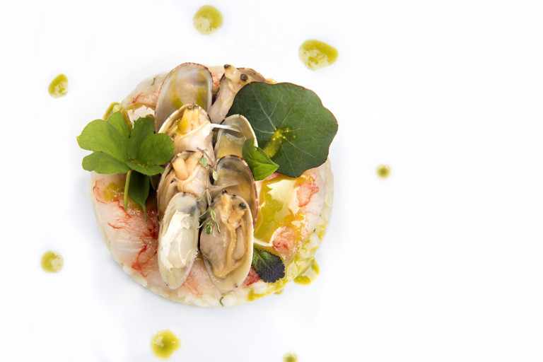 Vialone Nano risotto cremaed with lemon jam, raw prawns, clams and Bronte pistachio oil