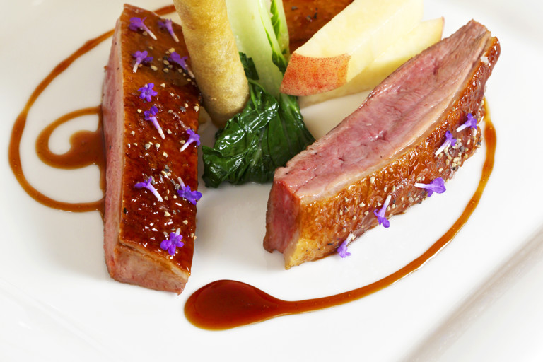 Roast crown of duck with turnip, peach, duck croustillant and red wine jus
