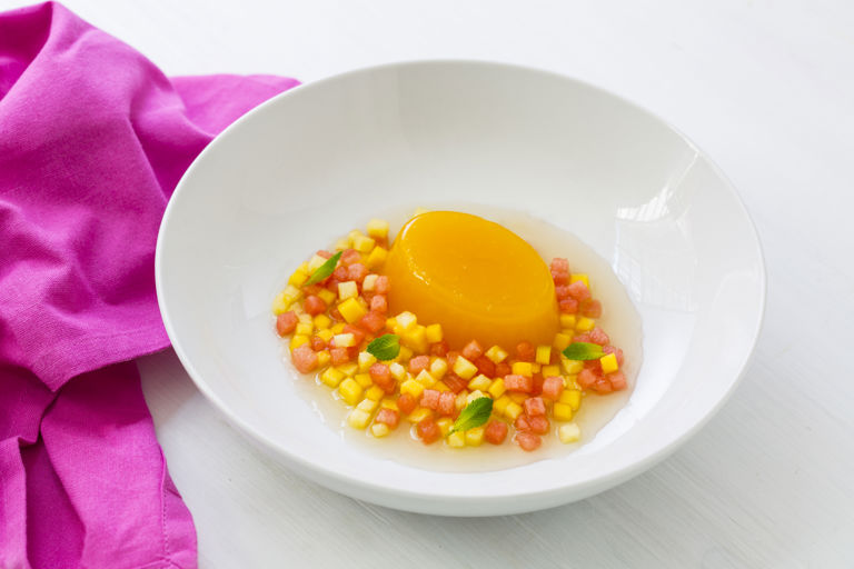 Orange jelly with cardamom and mint-infused pineapple, mango and melon