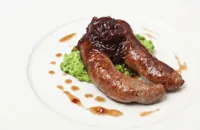 Grilled Norfolk sausages with crushed peas and onion marmalade