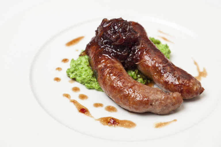 Grilled Norfolk sausages with crushed peas and onion marmalade