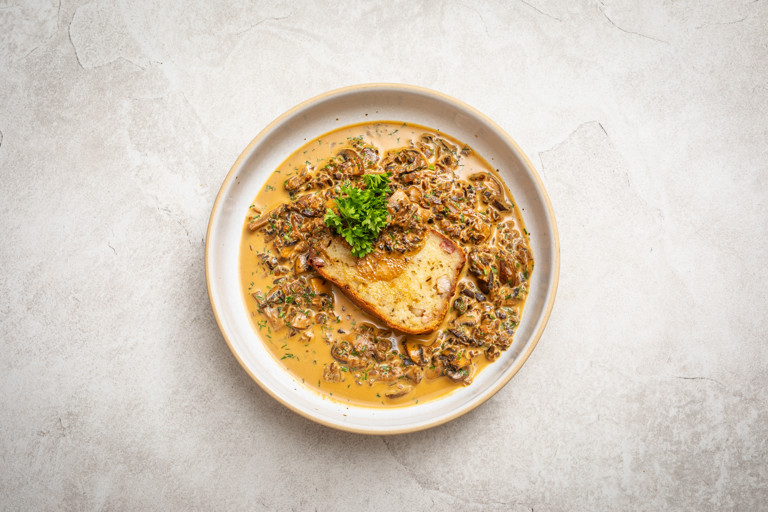 Babka ziemniaczana (Polish potato cake) with wild mushroom sauce