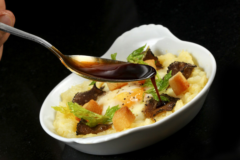 Baked hen's egg with crushed celeriac, truffle and croutons