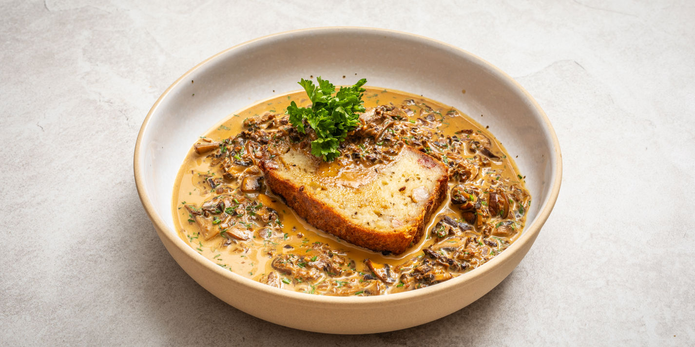 Babka ziemniaczana with wild mushroom sauce, plated