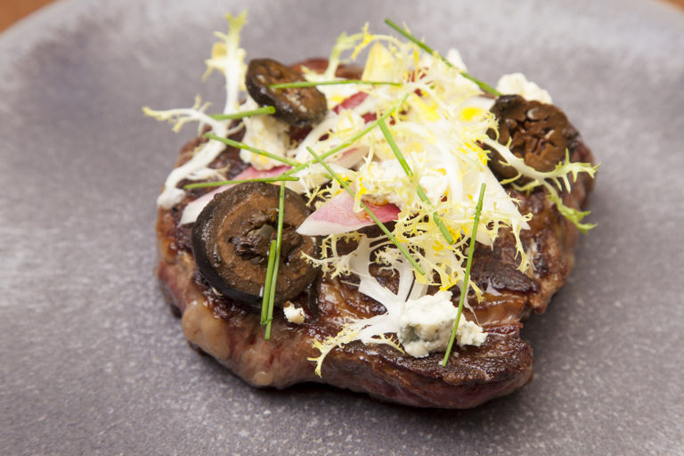 Ribeye steak with chicory, blue cheese and pickled walnuts