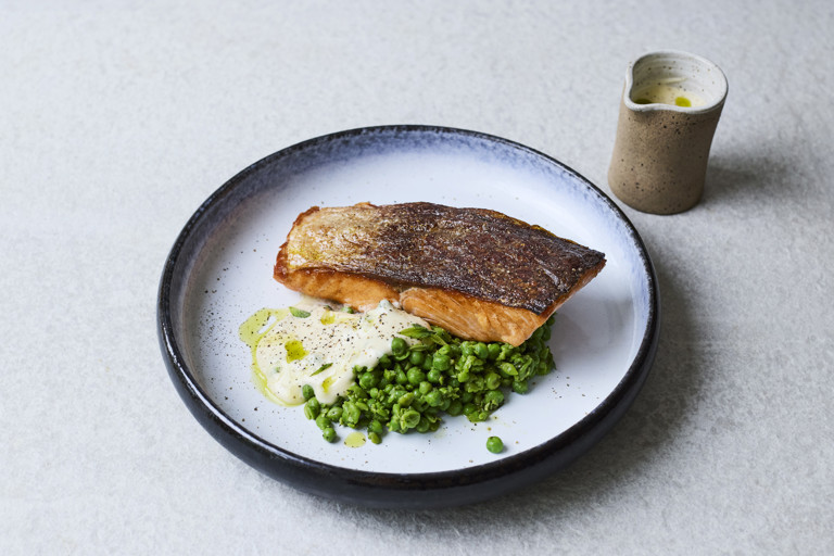Crispy salmon with beurre blanc, crushed peas and parsley oil
