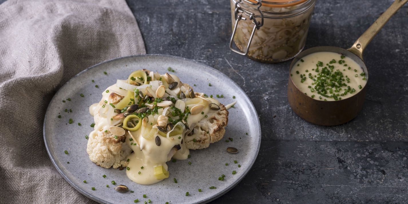 Roast cauliflower with smoked cheddar sauce, pickled leeks, nuts and seeds-image