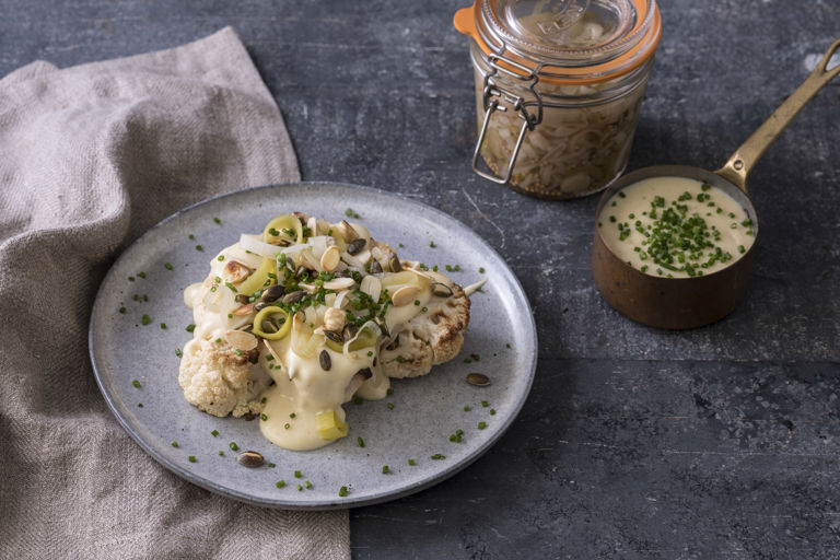 Roast cauliflower with smoked cheddar sauce, pickled leeks, nuts and seeds