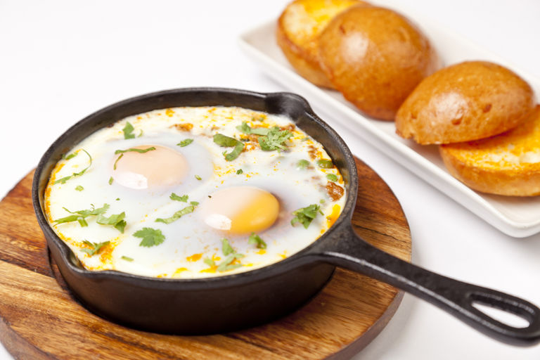 Baked eggs, minced lamb and peas