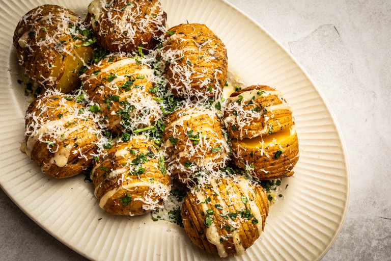 Barbecued hasselback potatoes with garlic butter and Gruyère