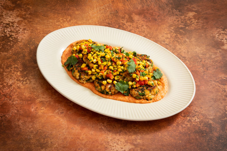Cajun-spiced cod cakes with red pepper sauce and sweetcorn salsa
