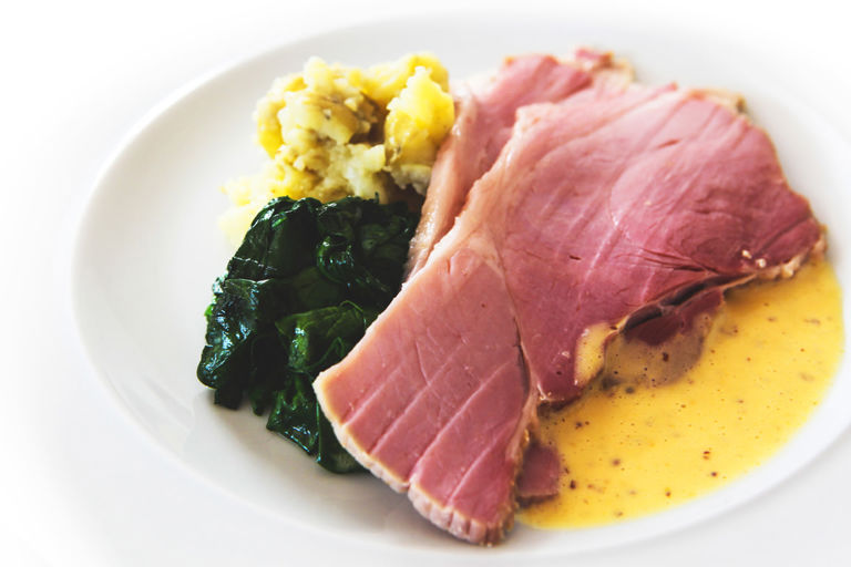 Smoked gammon baked in bran with crushed potatoes, poached egg, grain mustard dressing