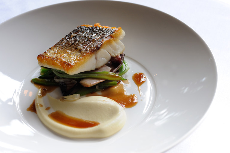 Escalope of wild sea bass with sautéed smoked bacon, red chicory, runner beans and red wine sauce 
