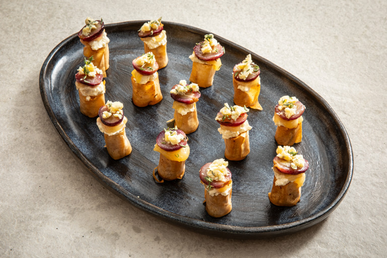 Stilton and mascarpone filo rolls with lemon curd and roasted grapes