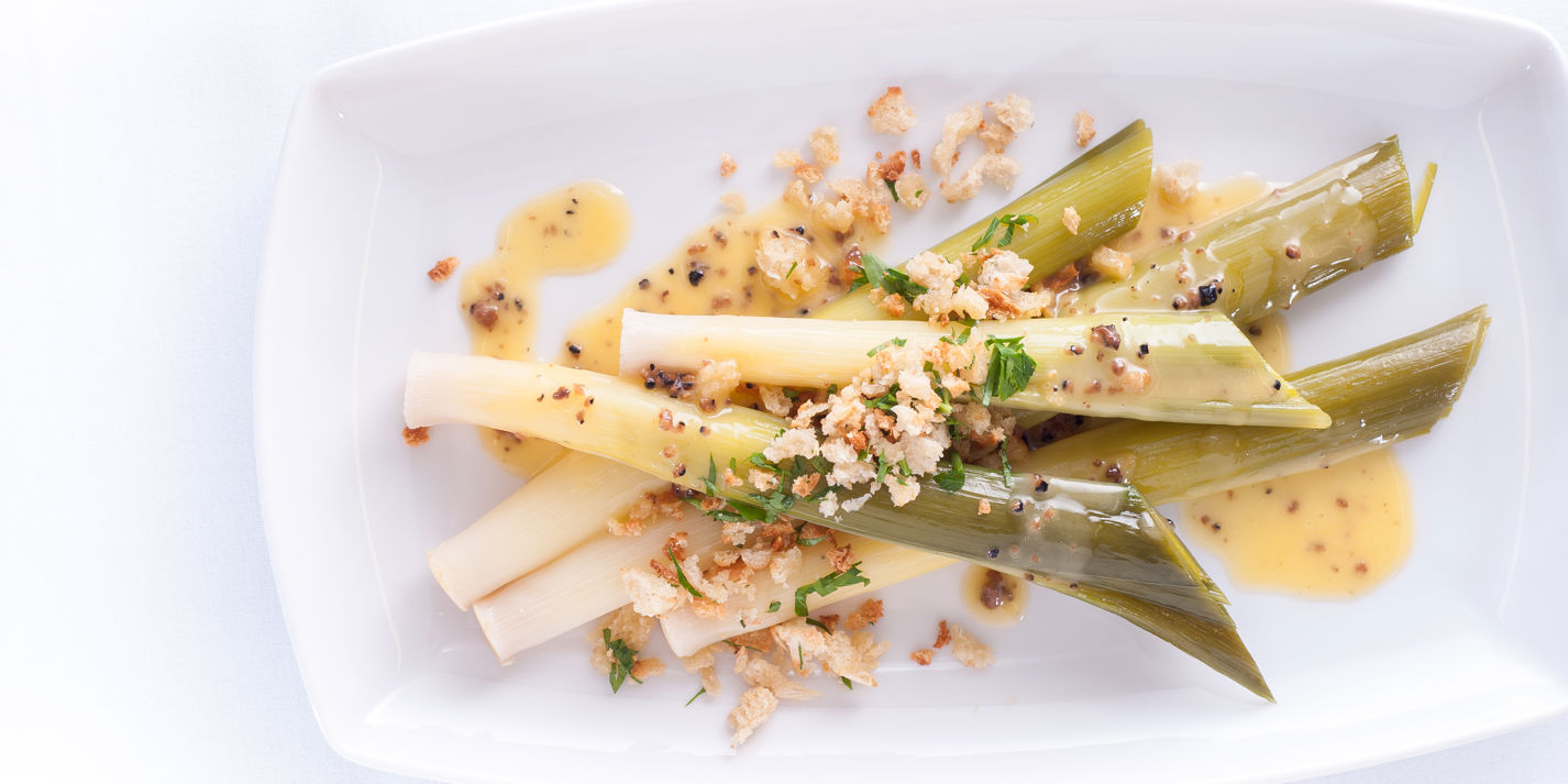 Baby leeks with truffle butter sauce and a garlic and herb crumb
