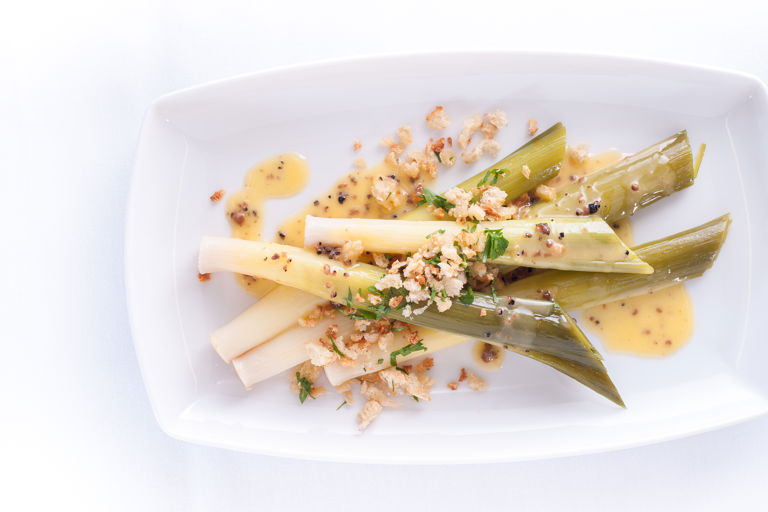 Baby leeks with truffle butter sauce and a garlic and herb crumb