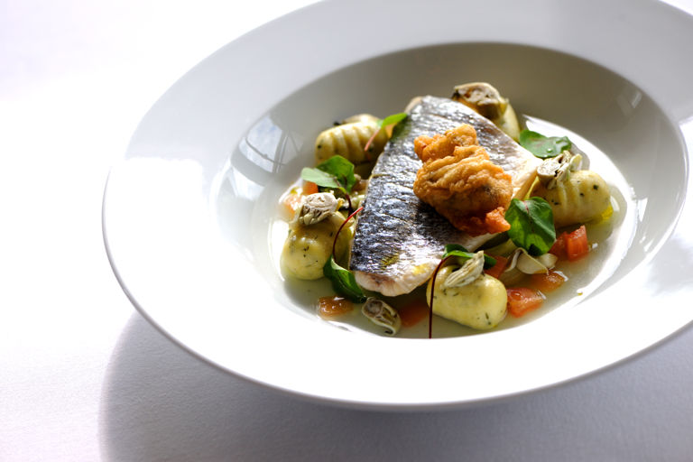 Steamed fillet of sea bream with a nage of Cornish oyster, tomatoes and cucumber and herb gnocchi