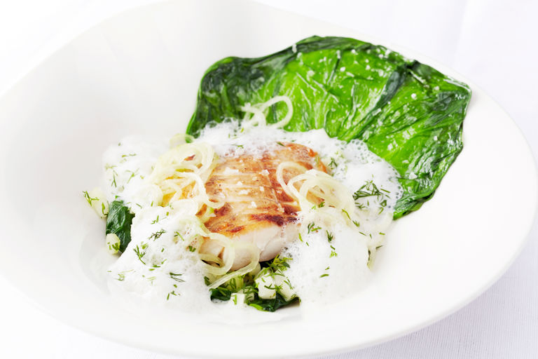Pan-fried sea bass fillet and mousseline raviolo, steamed lettuce and cucumber