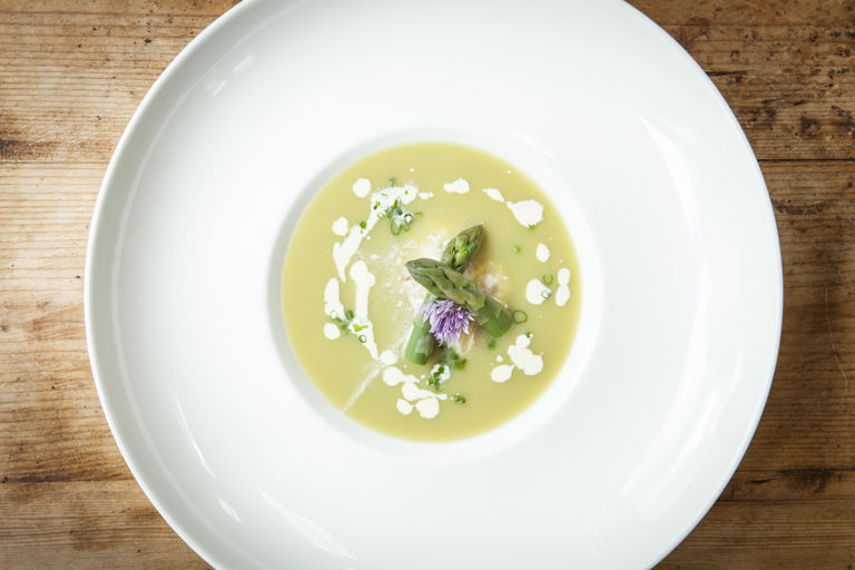 Cream of asparagus soup with flaked smoked haddock
