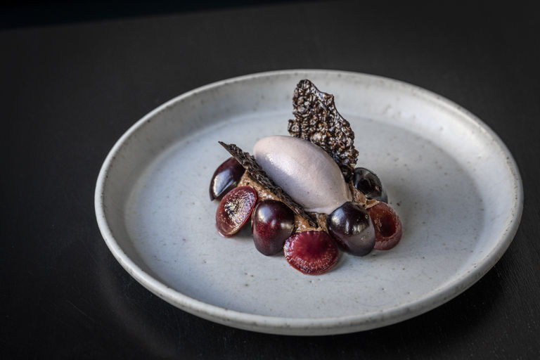 Chocolate cream cheese with poached cherries, cherry ice cream and cacao nib tuile