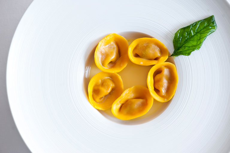 Tomato tortelli, water of provola cheese and basil crisps