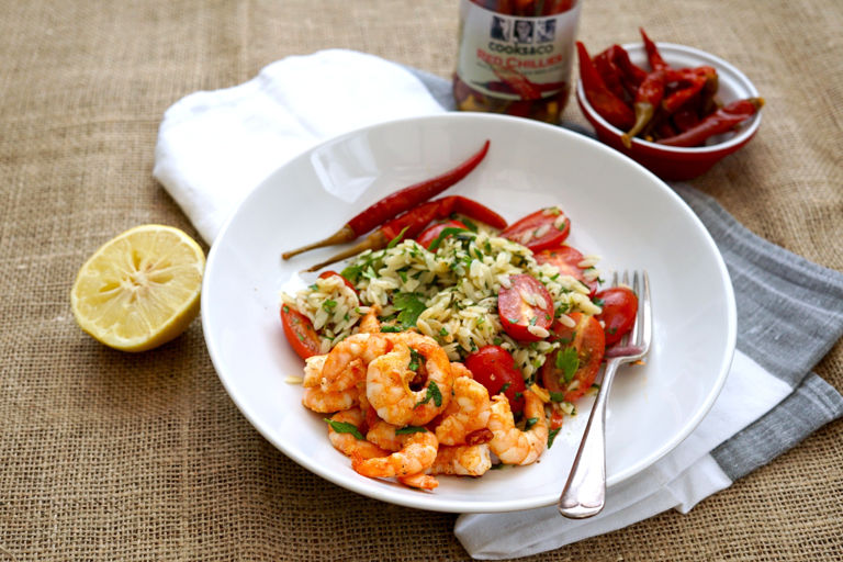 Sizzling prawns in chilli butter with orzo, herb and tomato salad