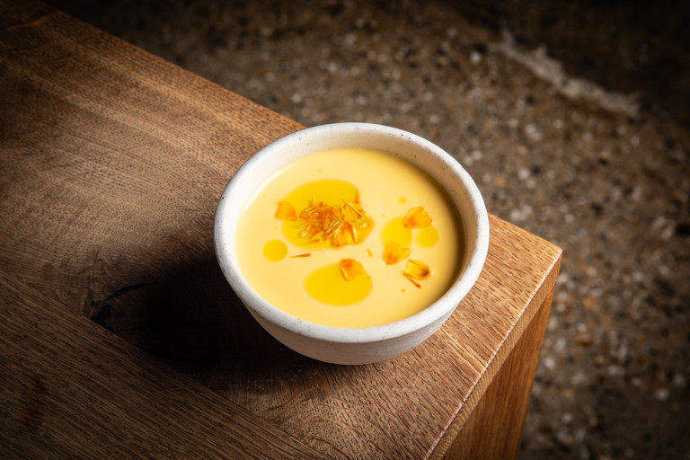 Chilled melon and cucumber soup with raw scallop and marigold