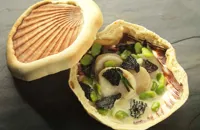 Orkney scallops baked in the shell with morels and broad beans