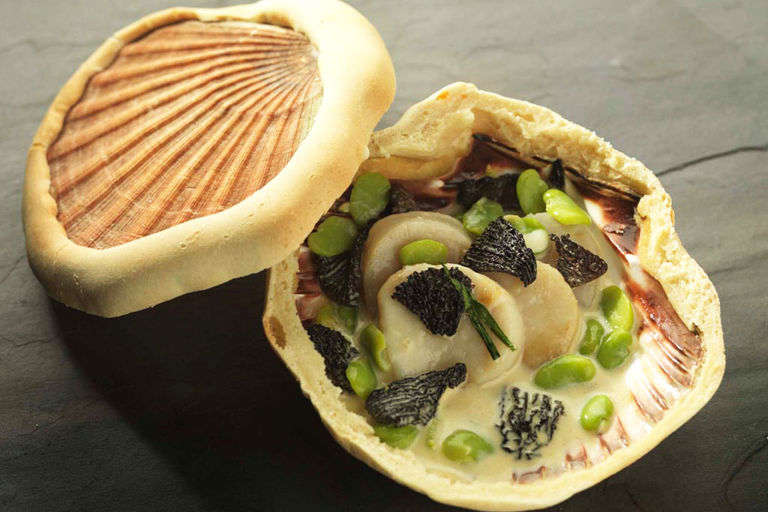 Orkney scallops baked in the shell with morels and broad beans