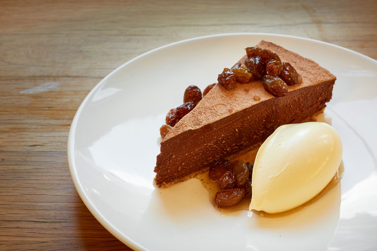 Chocolate tart with rum-soaked raisins and clotted cream